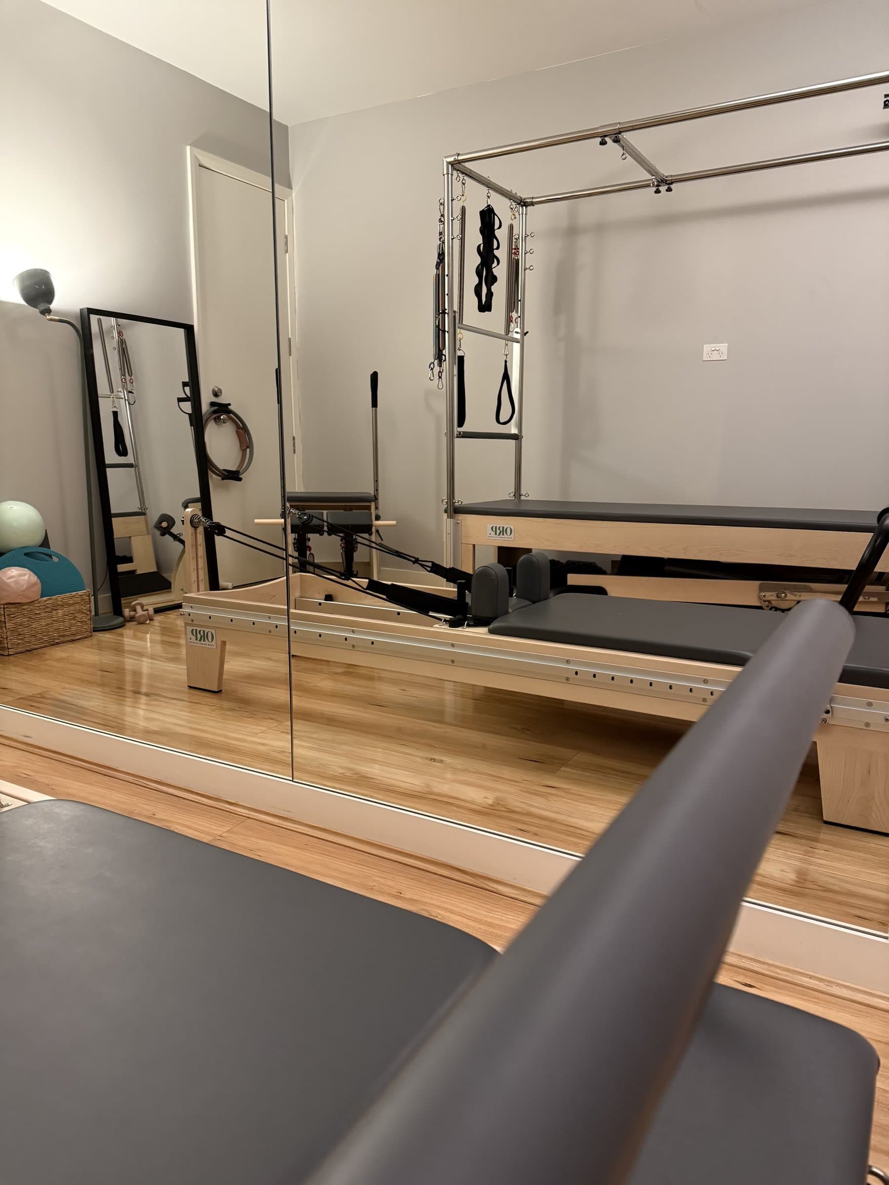Open Range Pilates studio interior showing reformers, cadillac tower, and barrel