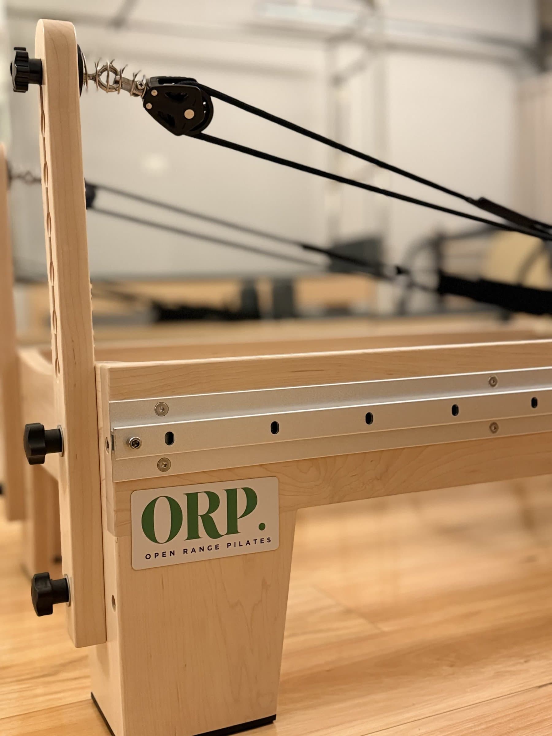 Close-up of Open Range Pilates reformer with ORP branding